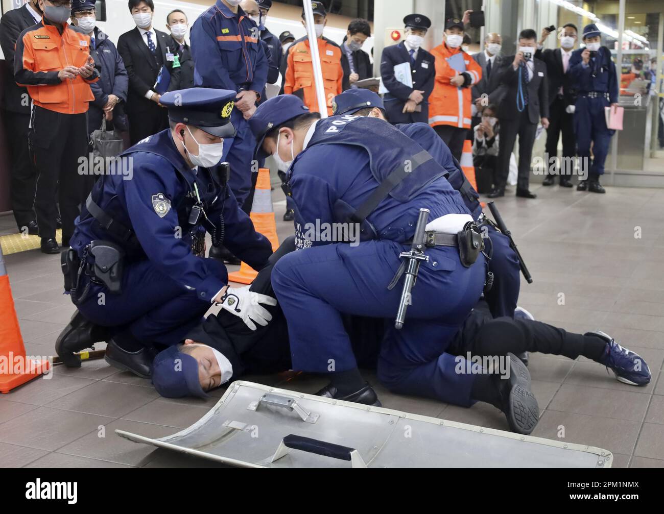 Police officers practice subduing a suspect during an anti