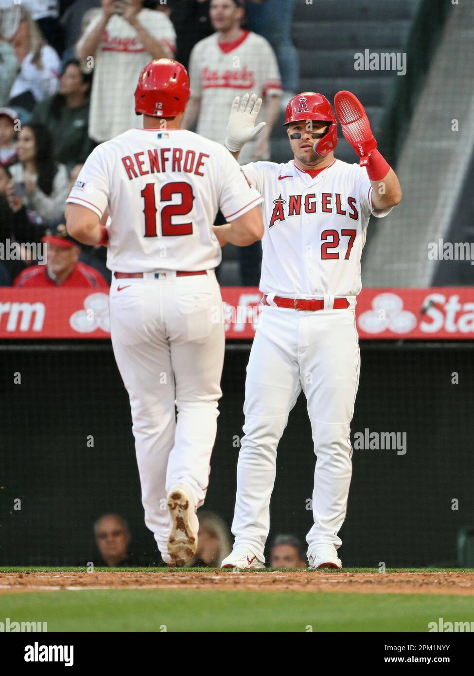ANAHEIM, CA - APRIL 10: Los Angeles Angels center fielder Mike Trout (27)  greets right fielder Hunter Renfroe (12) at the plate after both scored on  a Angels hit in the first