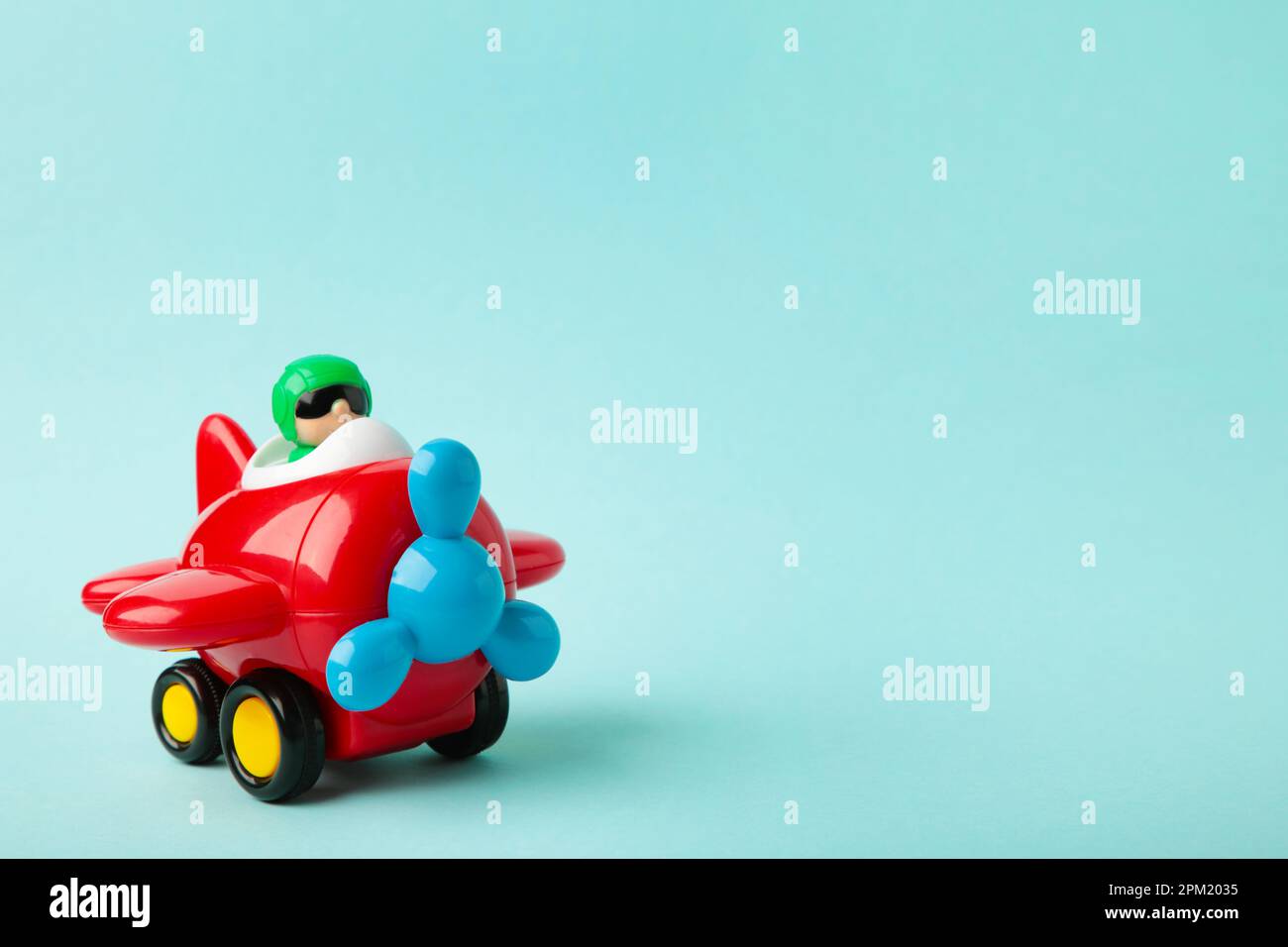 Plastic toy plane on blue background. Top view Stock Photo