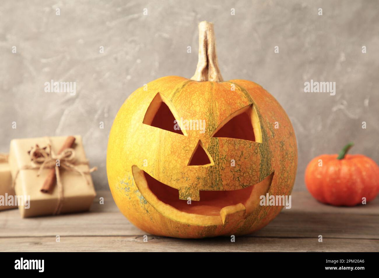 Halloween pumpkin with gifts on grey background. Top view Stock Photo