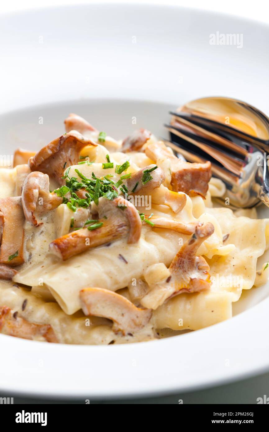 cream sauce with chanterelles served with pasta Stock Photo Alamy