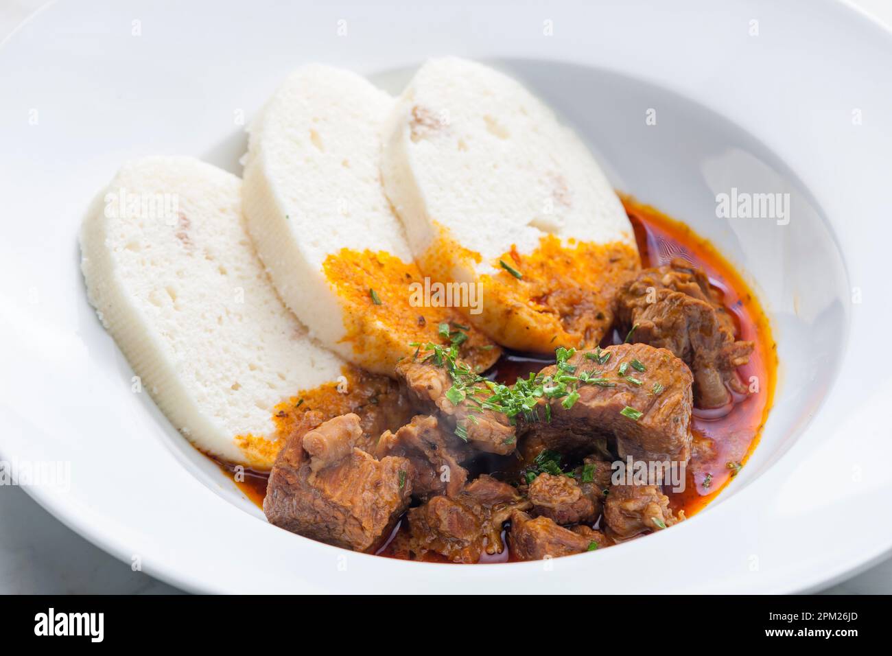 beef goulash served with dumplings Stock Photo