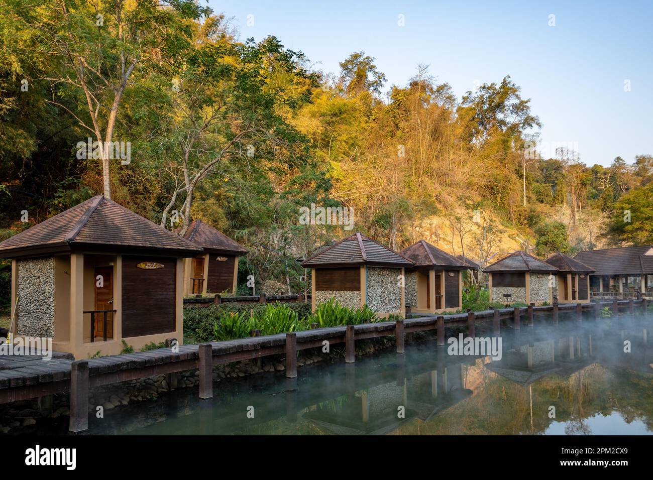 Bath huts line hot spring pool. Fang Hot Spring. Doi Pha Hom Pok National Park, Chiang Mai, Thailand. Stock Photo