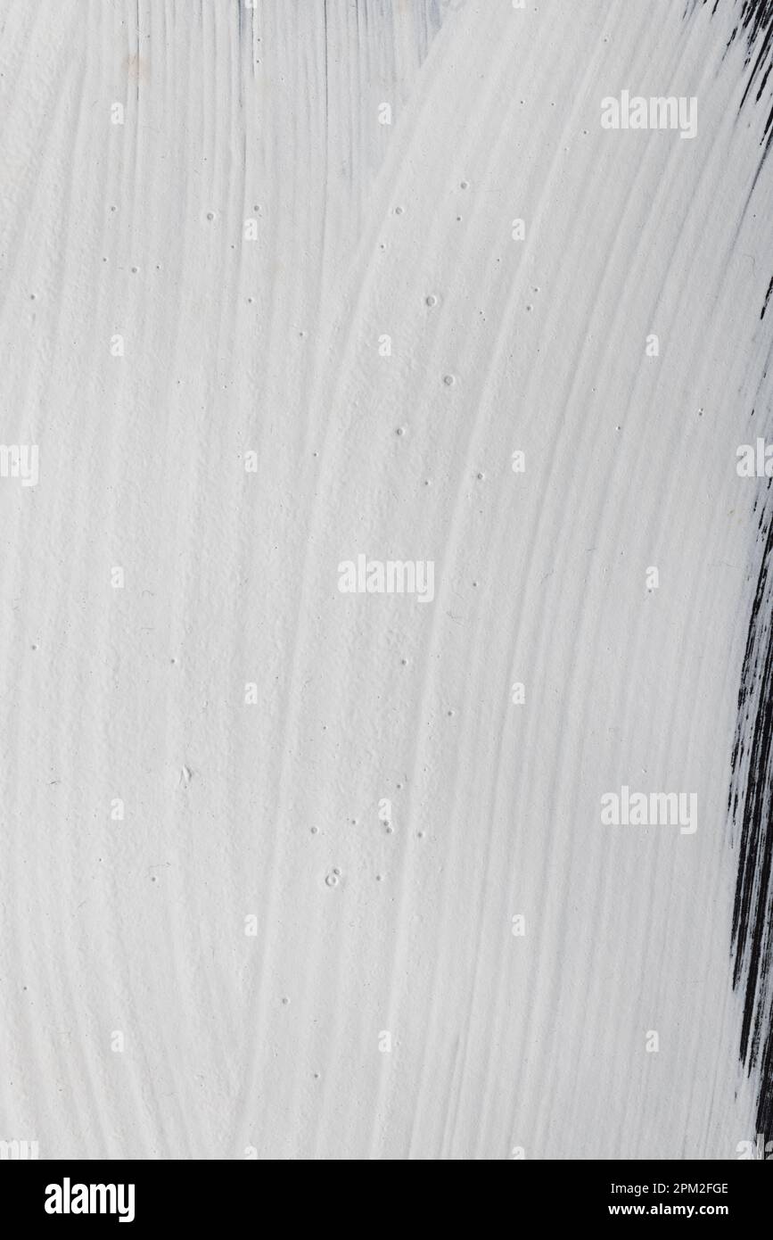Close up of white paint on black background with copy space Stock Photo