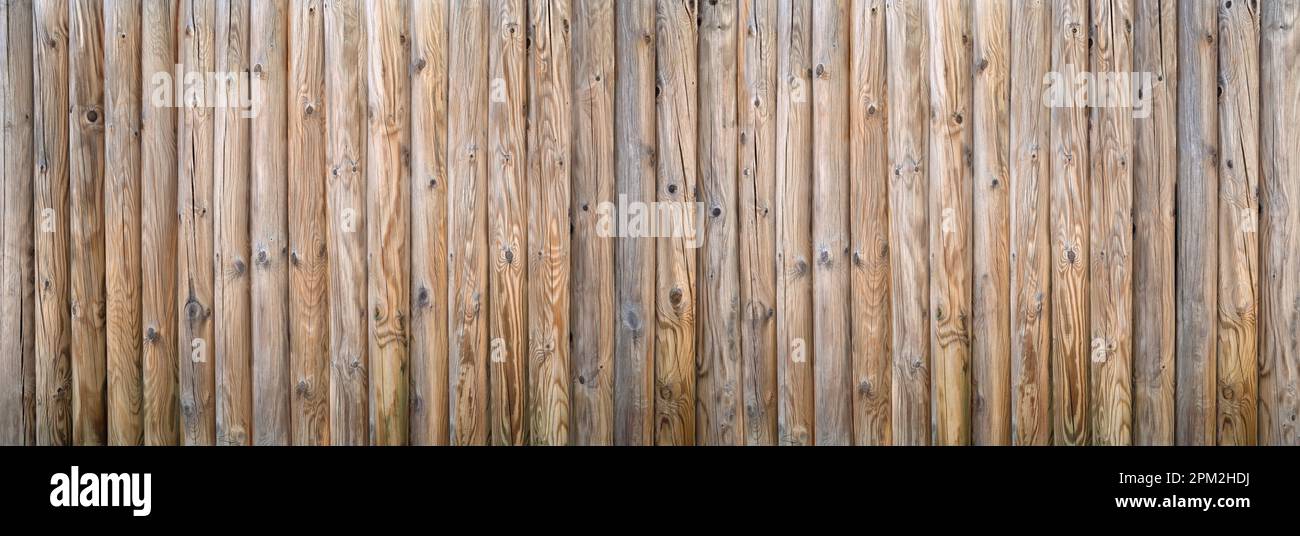 Privacy fence made of thick round woods with strong wood grain Stock Photo
