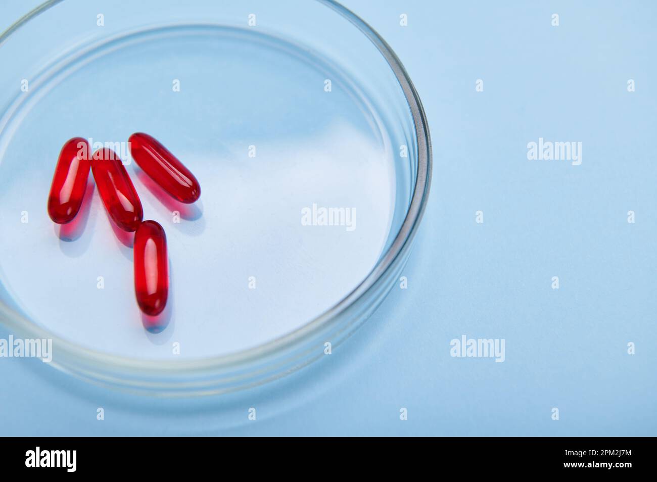 Red gelatin translucent capsules with fatsoluble vitamin E, essential