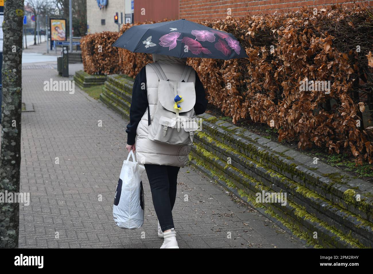 Kastrup/Copenhagen /Denmark/11 April 2023/Person walking in rainy fall