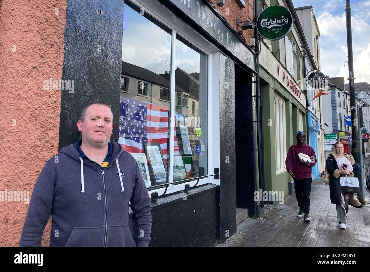 10 April 2023, Ireland, Ballina: Liam Naughton stands outside his pub. Naughton has spruced up the bar for the additional expected clientele. U.S. President Biden, some of whose ancestors hail from the small town in the west of Ireland, is expected in Belfast, neighboring Northern Ireland, on Tuesday evening (April 11) to celebrate the 25th anniversary of the Good Friday Agreement. Then as now, the U.S. was seen as the guarantor power of the agreement, which was at times seen as under threat due to Britain's exit from the EU. (to dpa ''Welcome Home Mr. President!' - Joe Biden in Northern Irela Stock Photo