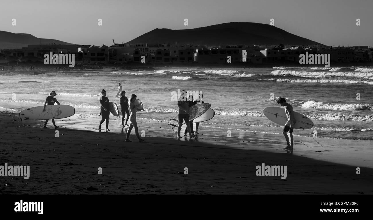 Black And White Photography, Surfer On The Beach, Playa Famara, Lanzarote, Canary Islands, Spain Stock Photo