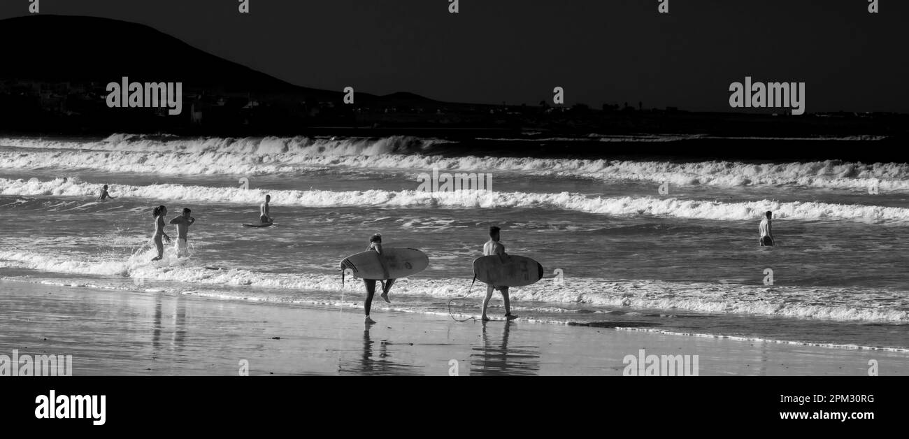Black And White Photography, Surfer On The Beach, Playa Famara, Lanzarote, Canary Islands, Spain Stock Photo