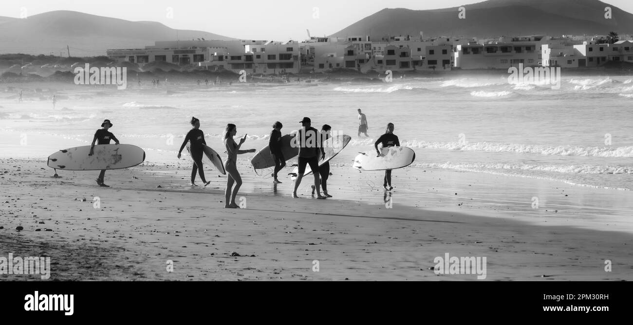 Black And White Photography, Surfer On Beach, Playa Famara, Lanzarote, Canary Islands, Spain Stock Photo