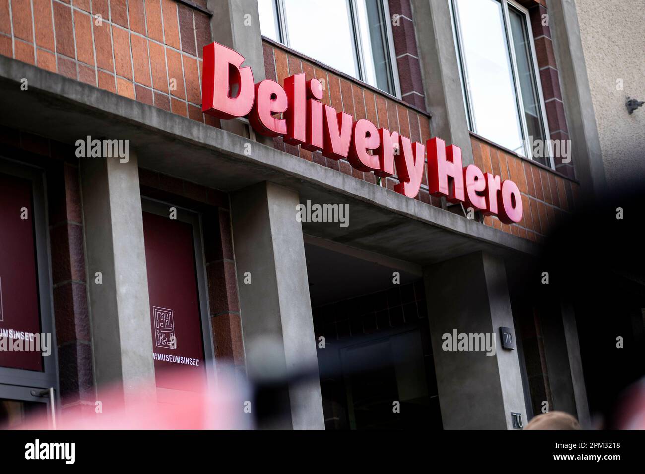 A logo of the company delivery hero at their company headquarters in  Berlin, April 4, 2023. Copyright: Leon Kuegeler/photothek.de Stock Photo -  Alamy