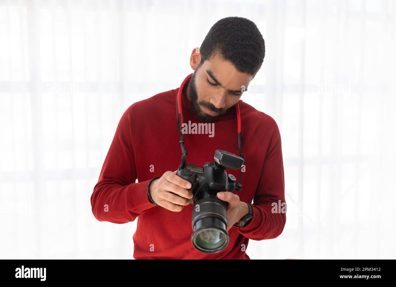 Handsome young man professional photographer using digital camera Stock Photo