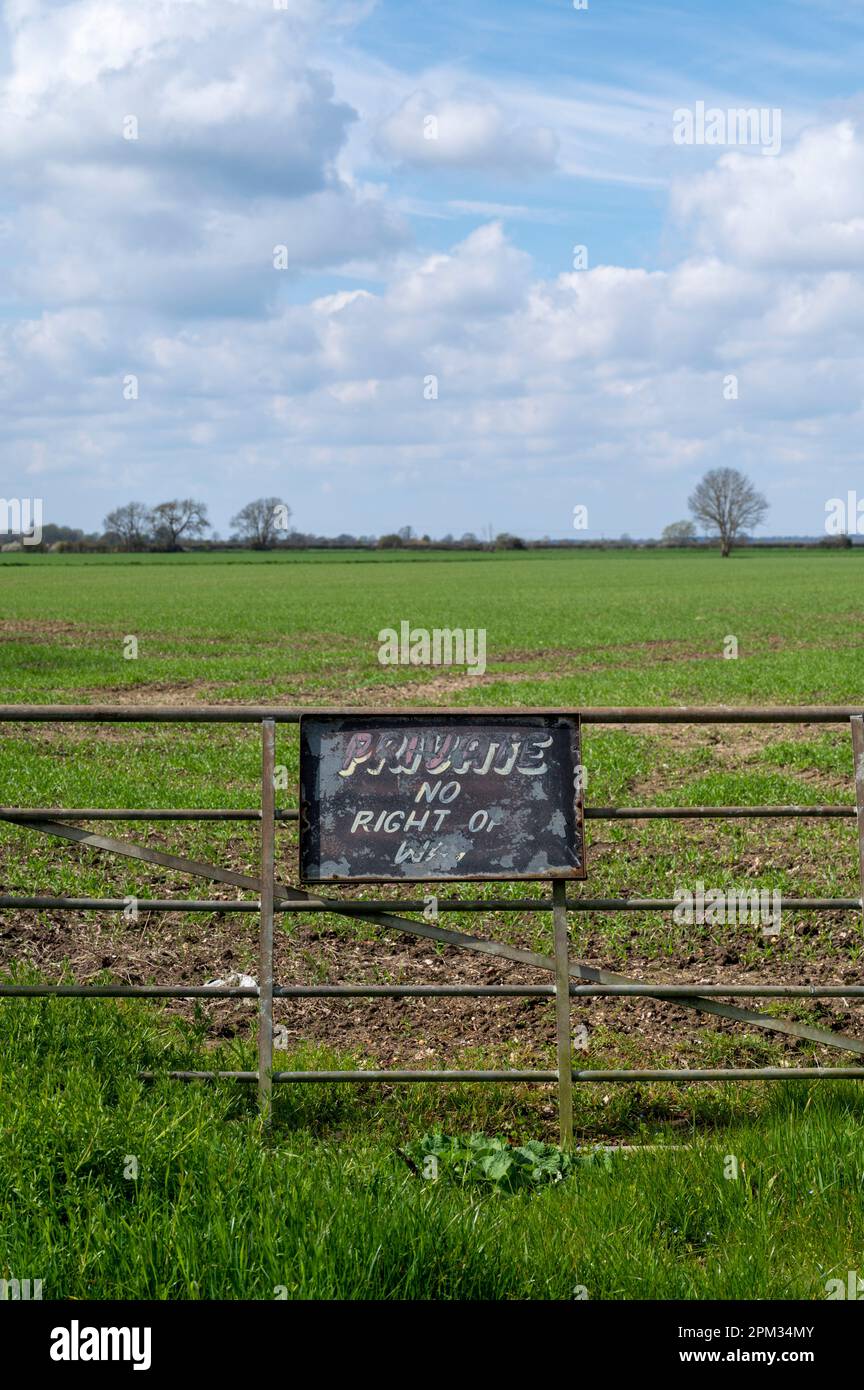 A locked gate and private no right of way sign at the entrance to a field in the Cambridgeshire Fens UK Stock Photo