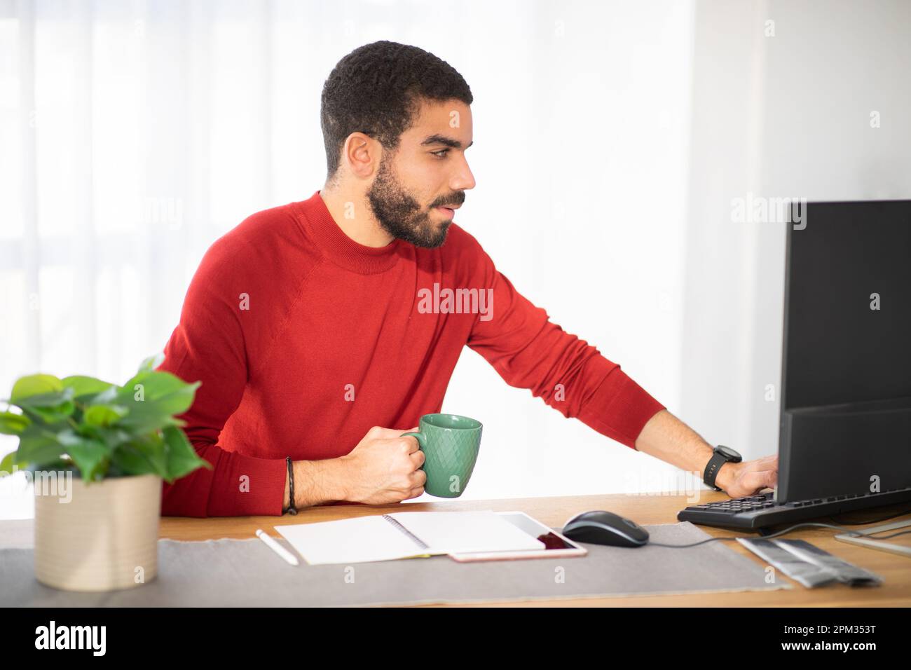 Handsome hispanic young man working at office Stock Photo
