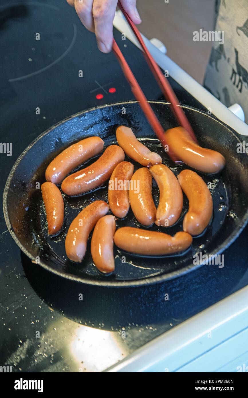 small swedish sausages in a brass pan Stock Photo