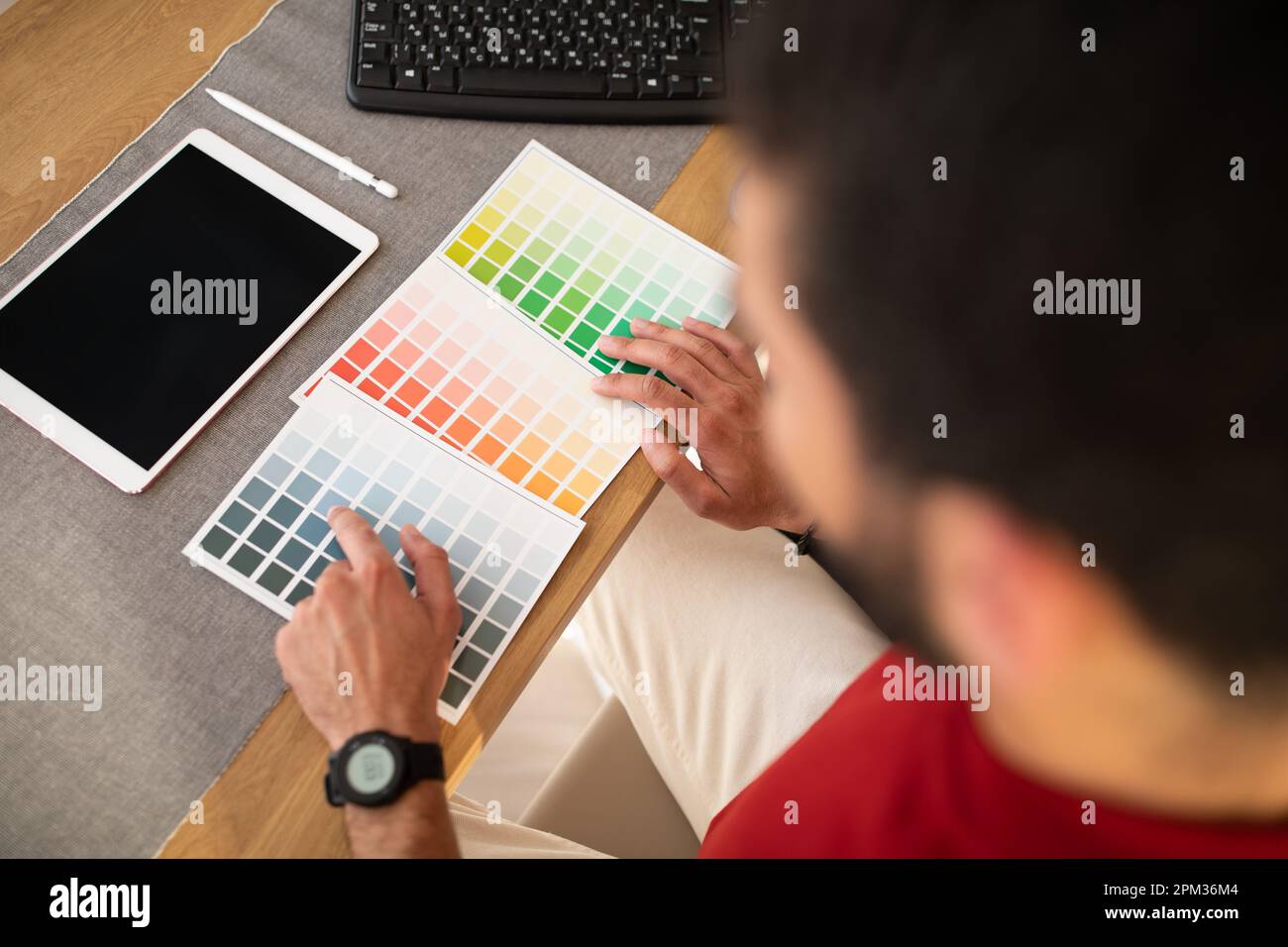 Male designer using graphics tablet in office, top view Stock Photo