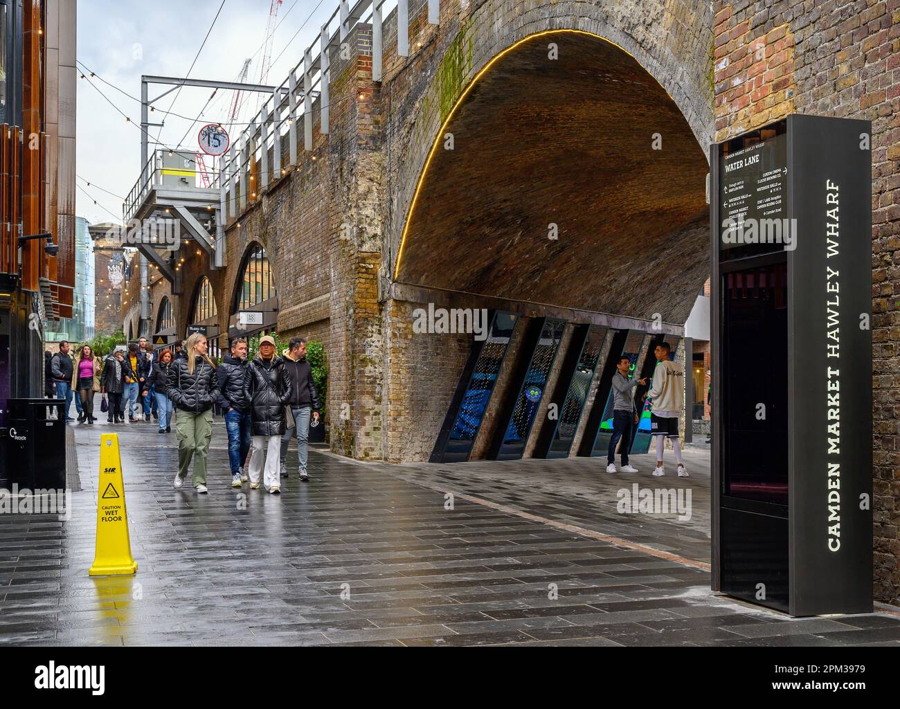 Camden Town, London, UK: Hawley Wharf, part of Camden Market. People walking in Water Lane by the railway viaduct. Stock Photo