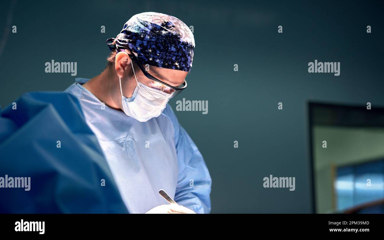 Portrait of a male surgeon in the operating room on the background of ...