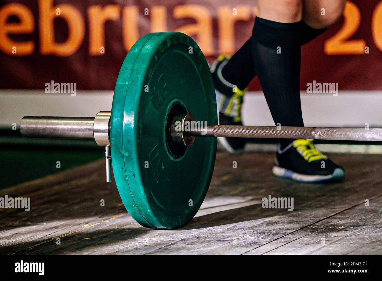 part barbell and legs powerlifter on wooden floor, powerlifting competition deadlift Stock Photo