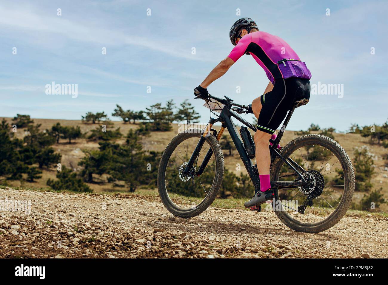 athlete mountainbiker biking uphill in cross-country cycling, outdoors summer race Stock Photo