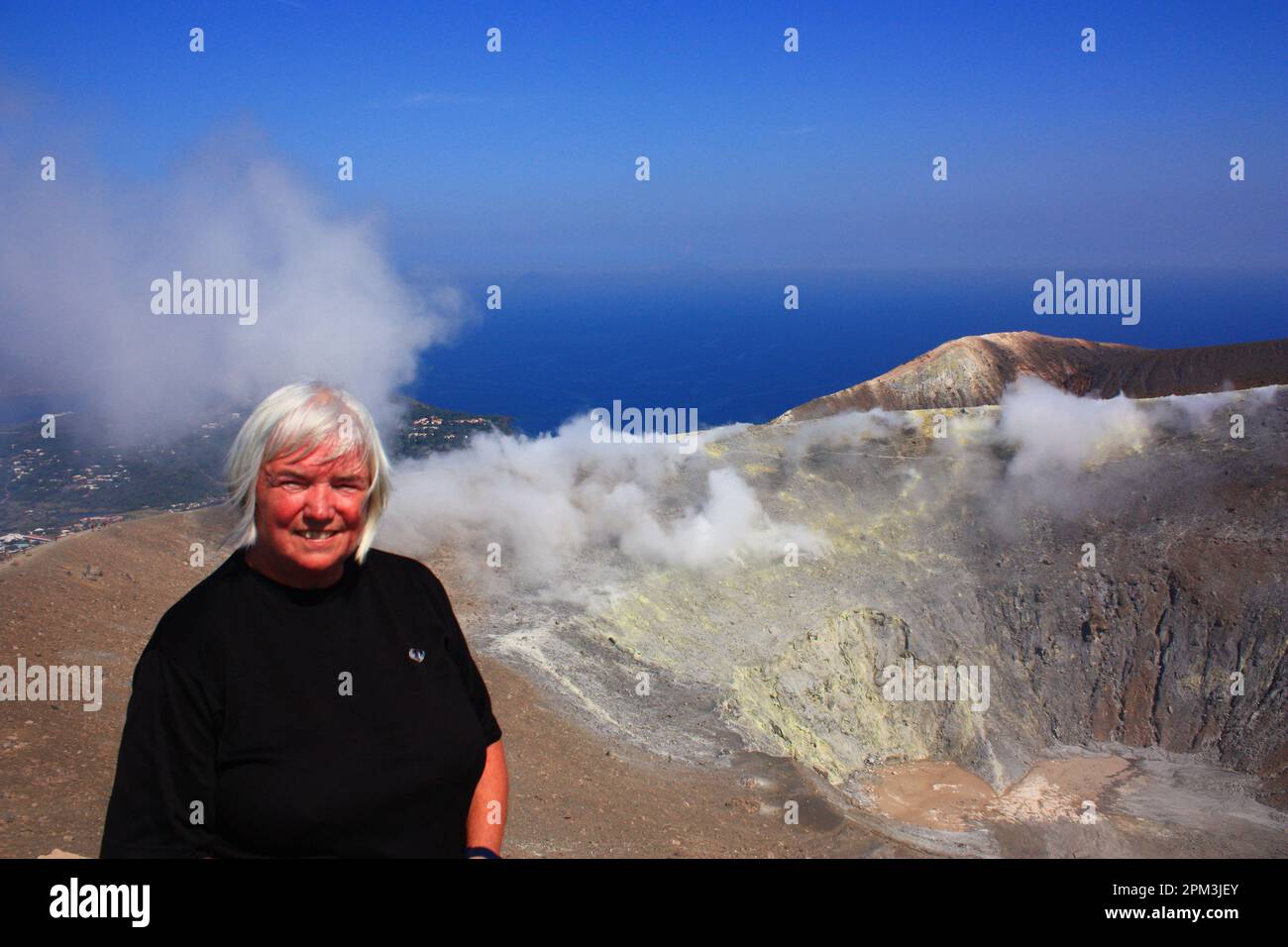 Woman on the crater of Vulcano Stock Photo