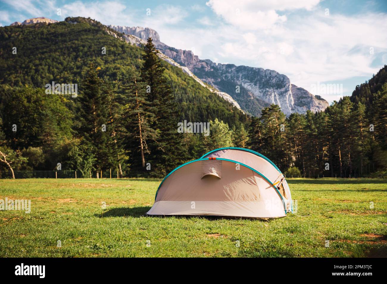 Tent with amazing landscape views of forest and mountains. Camping holiday and outdoor summer vacation. Lifestyle concept Stock Photo