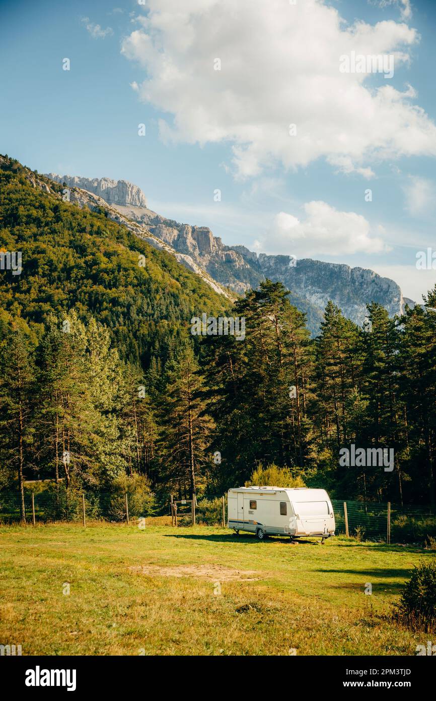 Caravan with amazing landscape views of forest and mountains. Camping holiday and outdoor summer vacation. Nomad lifestyle concept Stock Photo