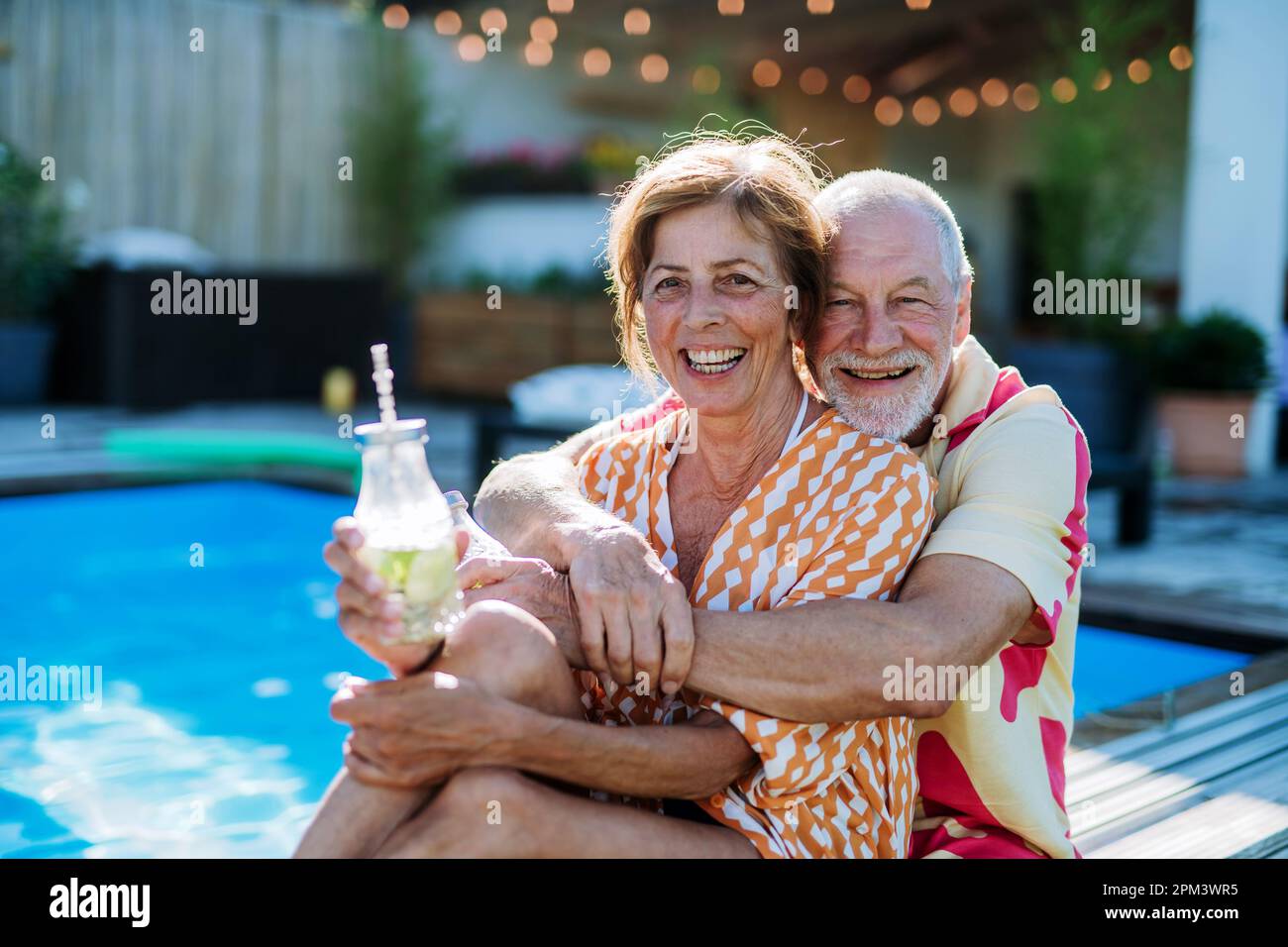 Happy senior couple enjoying drinks when relaxing and sitting by ...