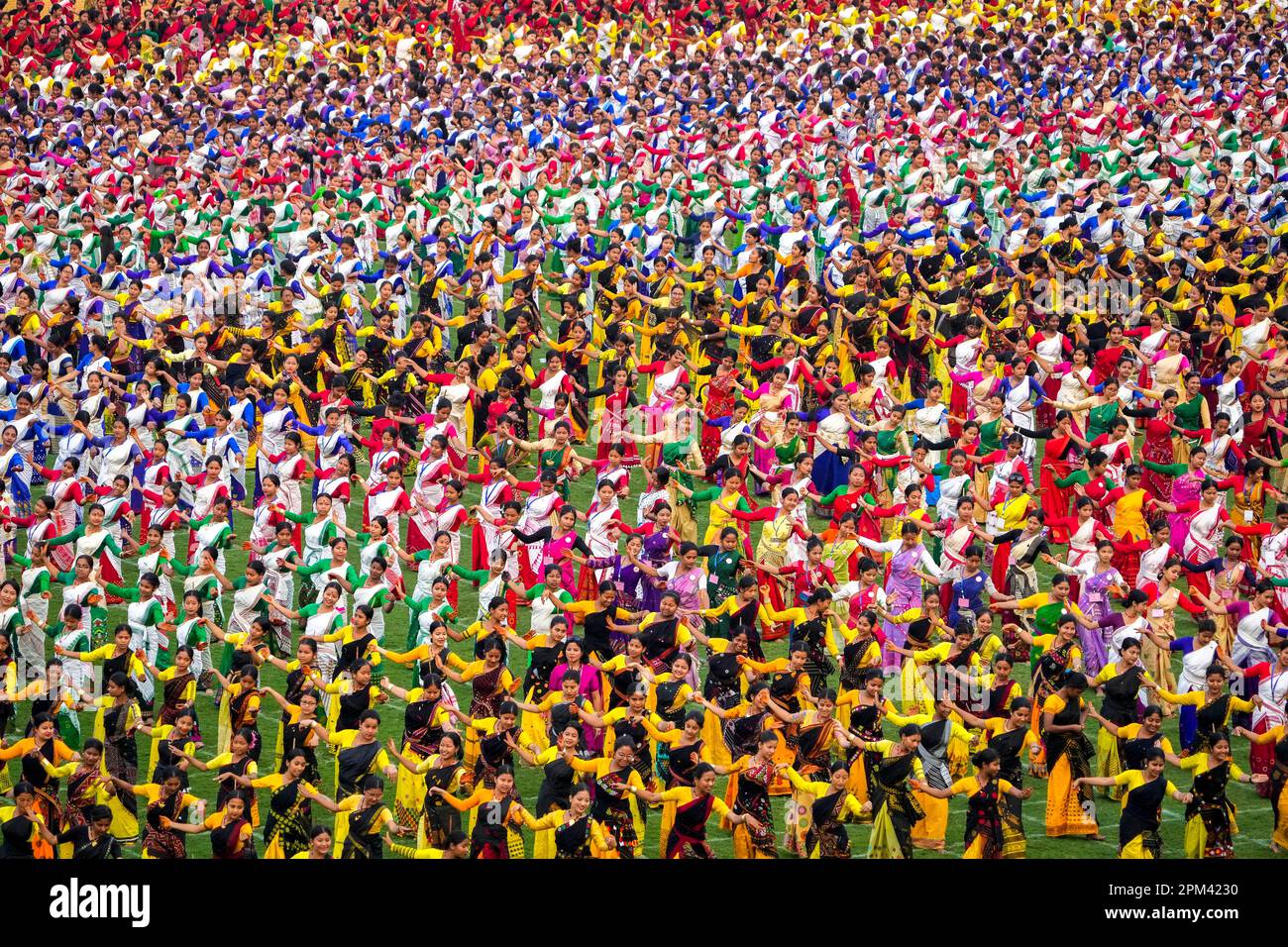 Assamese dancers in traditional attire practice Bihu dance ahead of an
