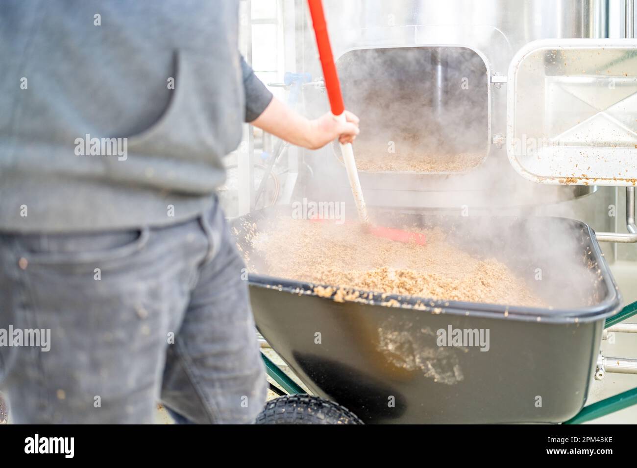 cleaning the boiler from residual malt after brewing beer in the