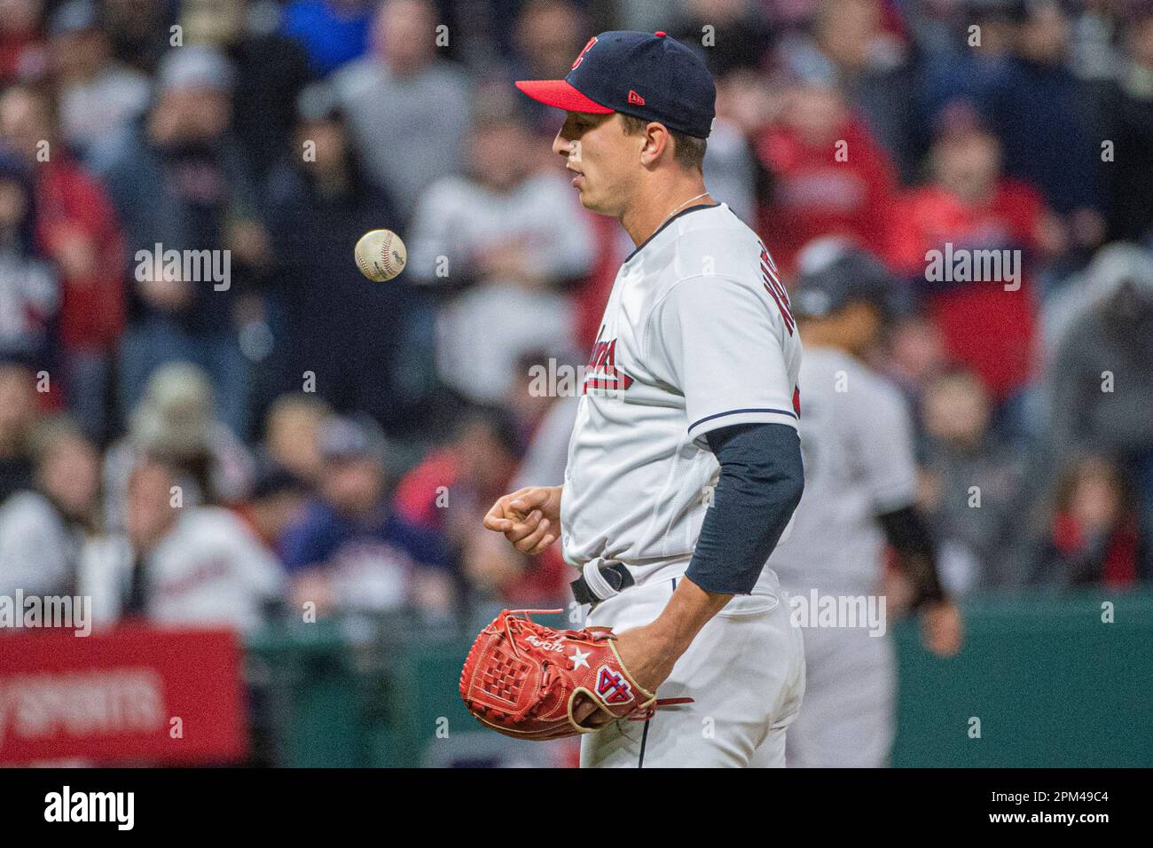 Cleveland Guardians relief pitcher James Karinchak flips the ball