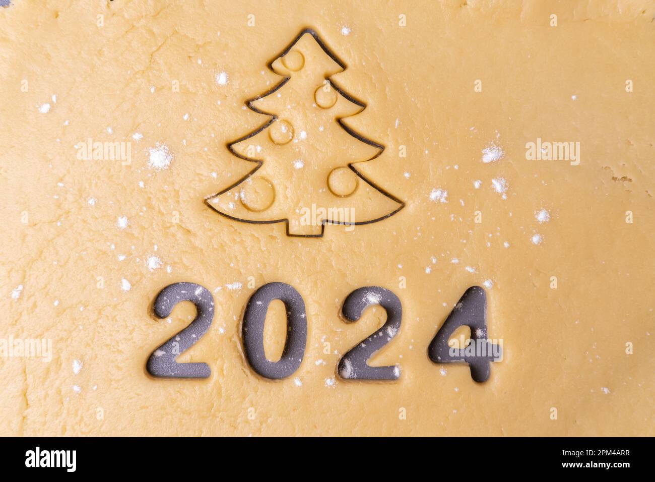 New year 2024. Cooking homemade organic cookies. Cutting out cookies in
