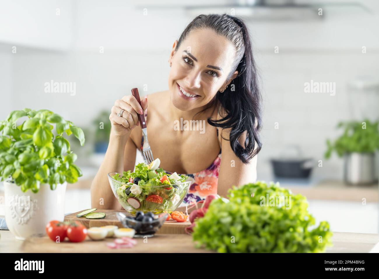 Healthy lifestyle young woman eating lettuce salad. Young