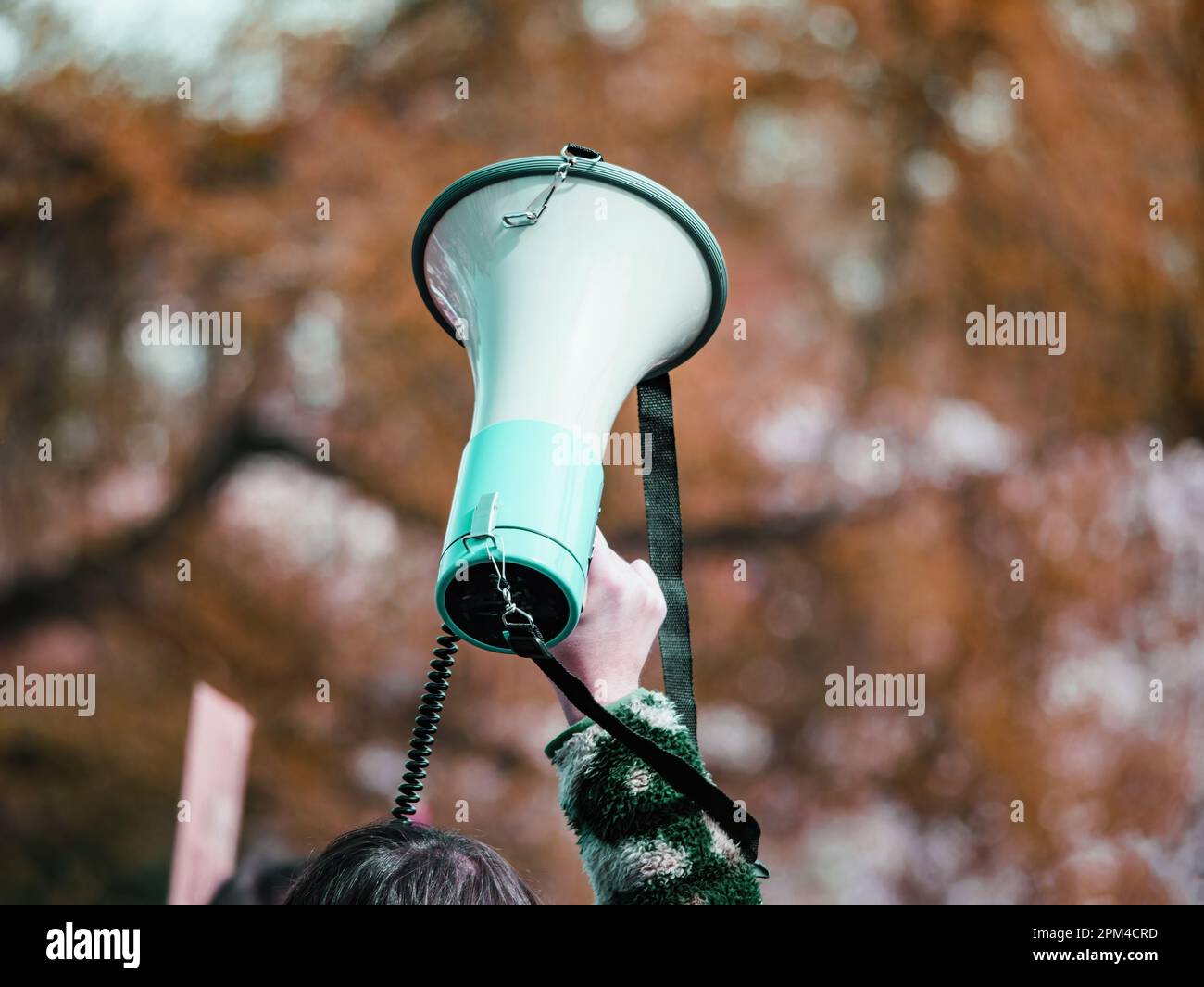 A diverse group of young activists march the streets, holding banners ...