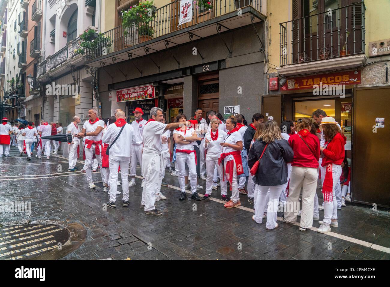 PAMPLONA, Spain - July 04 2022: Thousands of people gathered in the streets of Pamplona to celebrate El Chupinazo, the inauguration of the SAN FERMIN Stock Photo
