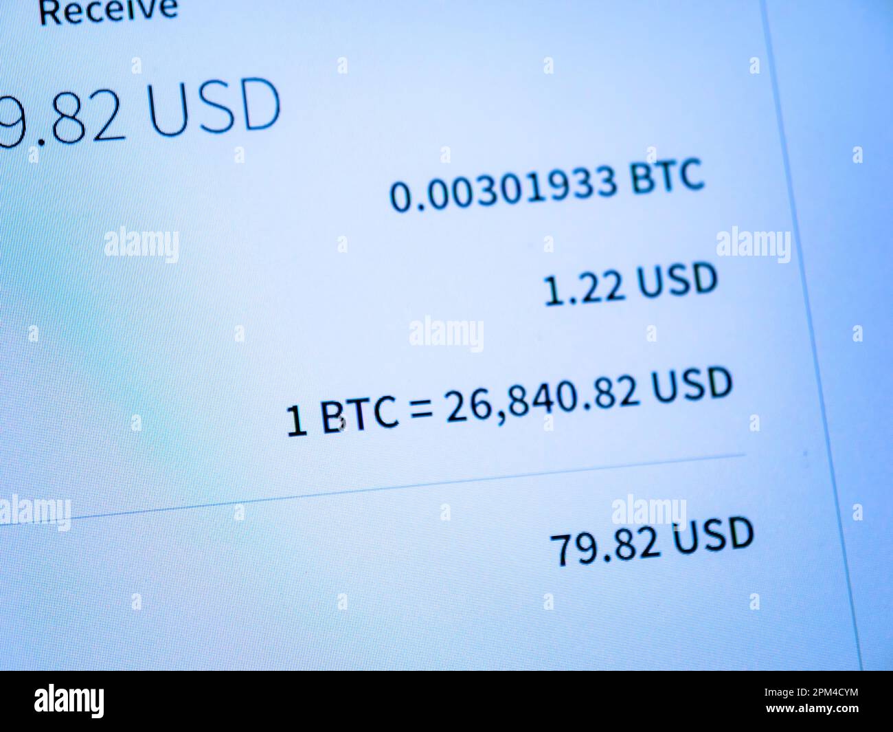Vienna, Austria, Mar 22, 2023: A close-up of a background with text,  graphs, and documents about bitcoin mining, exchange rates, fees and more.  A trader reviews order details to spend or receive