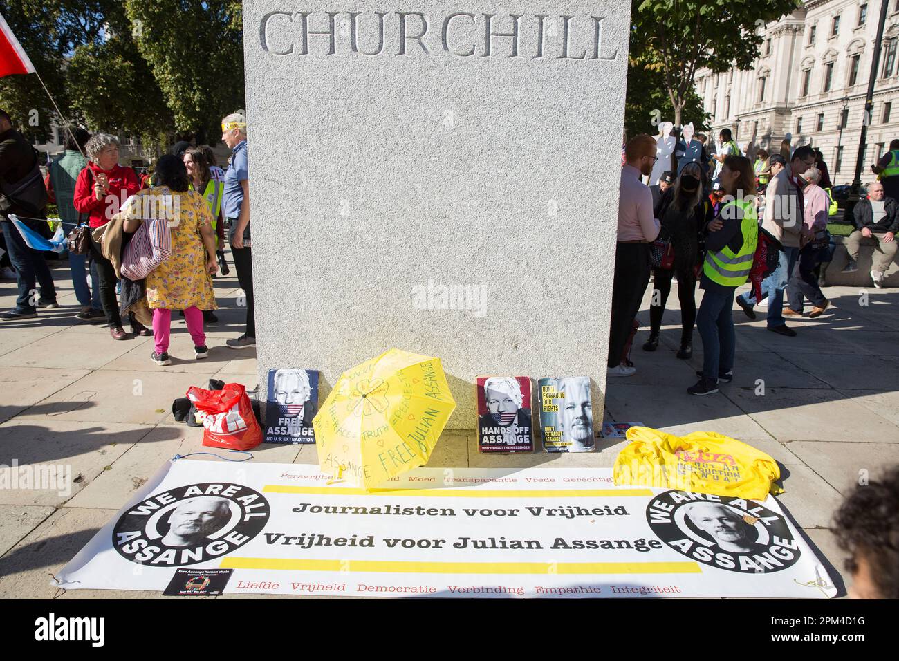 A banner and messages supporting WikiLeaks founder Julian Assange are displayed around the statue of Winston Churchill in Parliament Square, London. Stock Photo