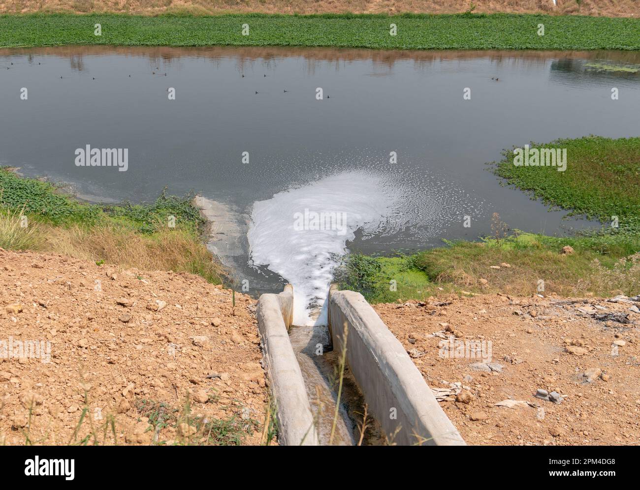 Drain gutter back of factory water flow to treatment pond. Stock Photo