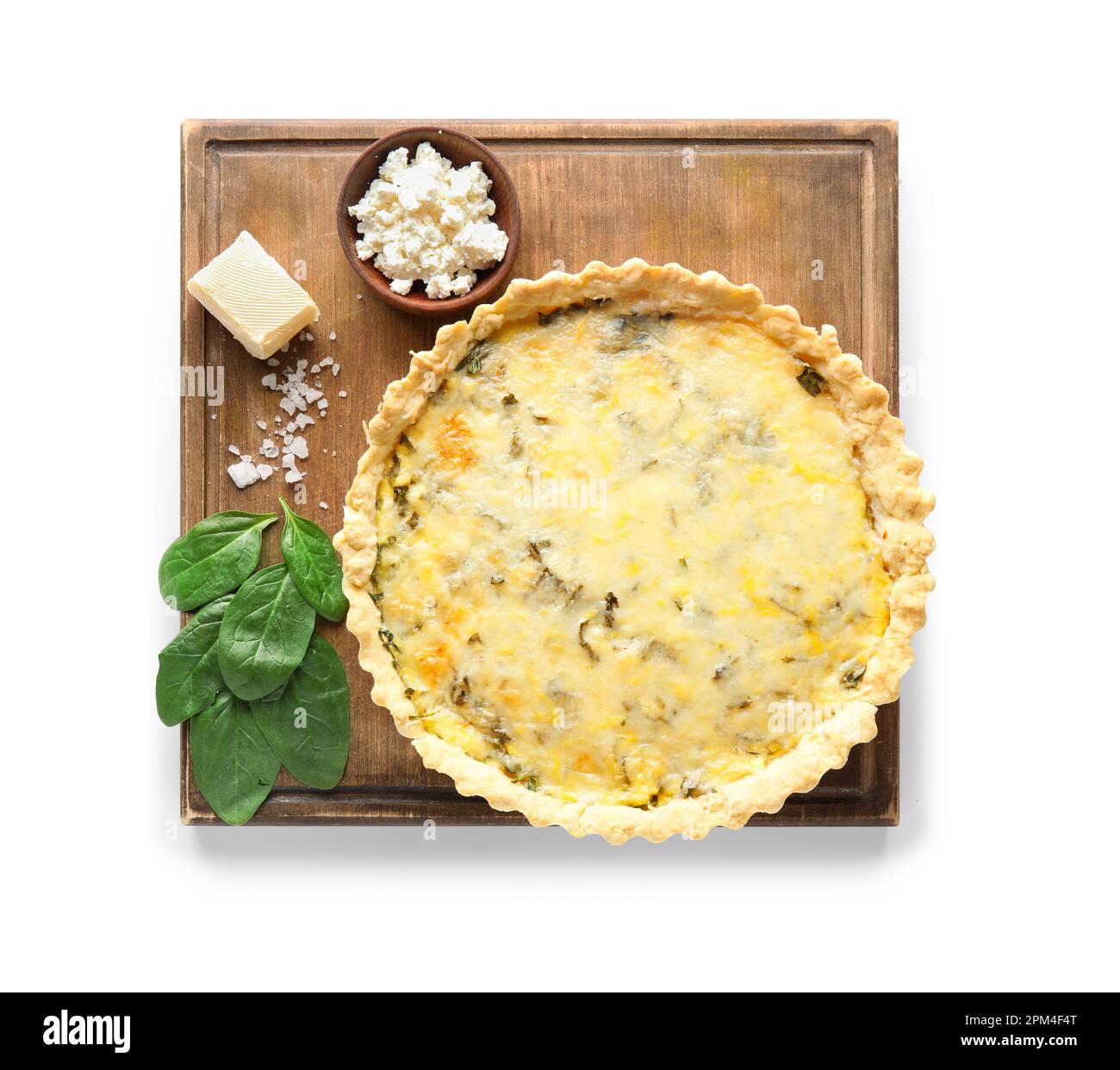 Board with delicious quiche, cottage cheese, feta and spinach leaves