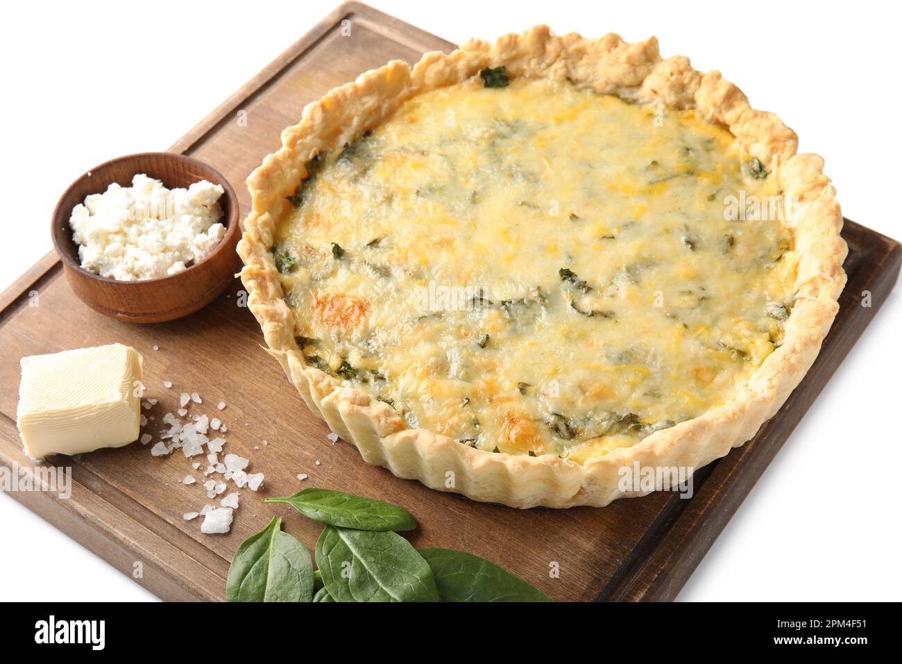 Board with delicious quiche, cottage cheese, feta and spinach leaves