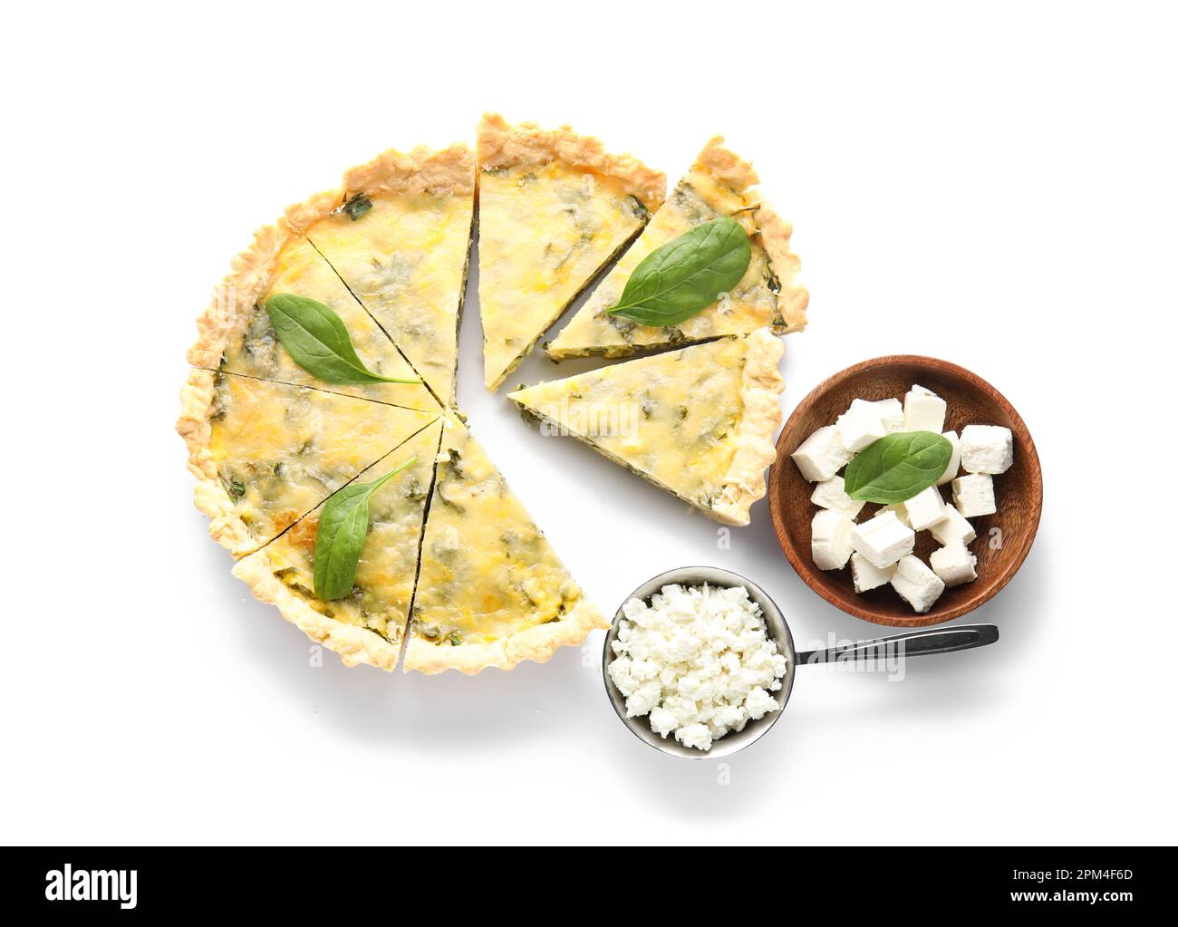Pieces of delicious quiche with spinach leaves, cottage and feta cheese