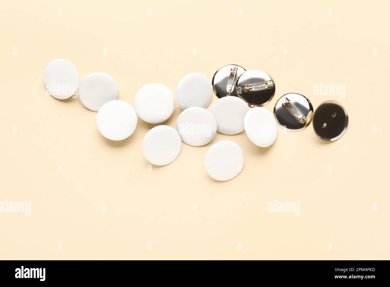 Blank white badges on beige background Stock Photo - Alamy