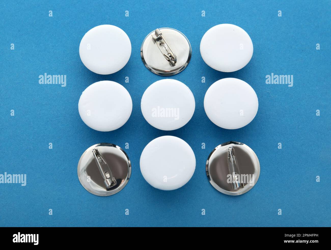 Blank white badges on blue background Stock Photo - Alamy