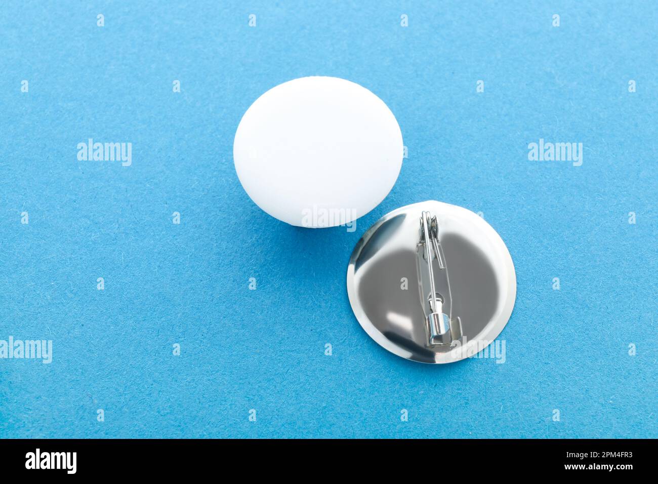 Blank white badges on blue background Stock Photo - Alamy