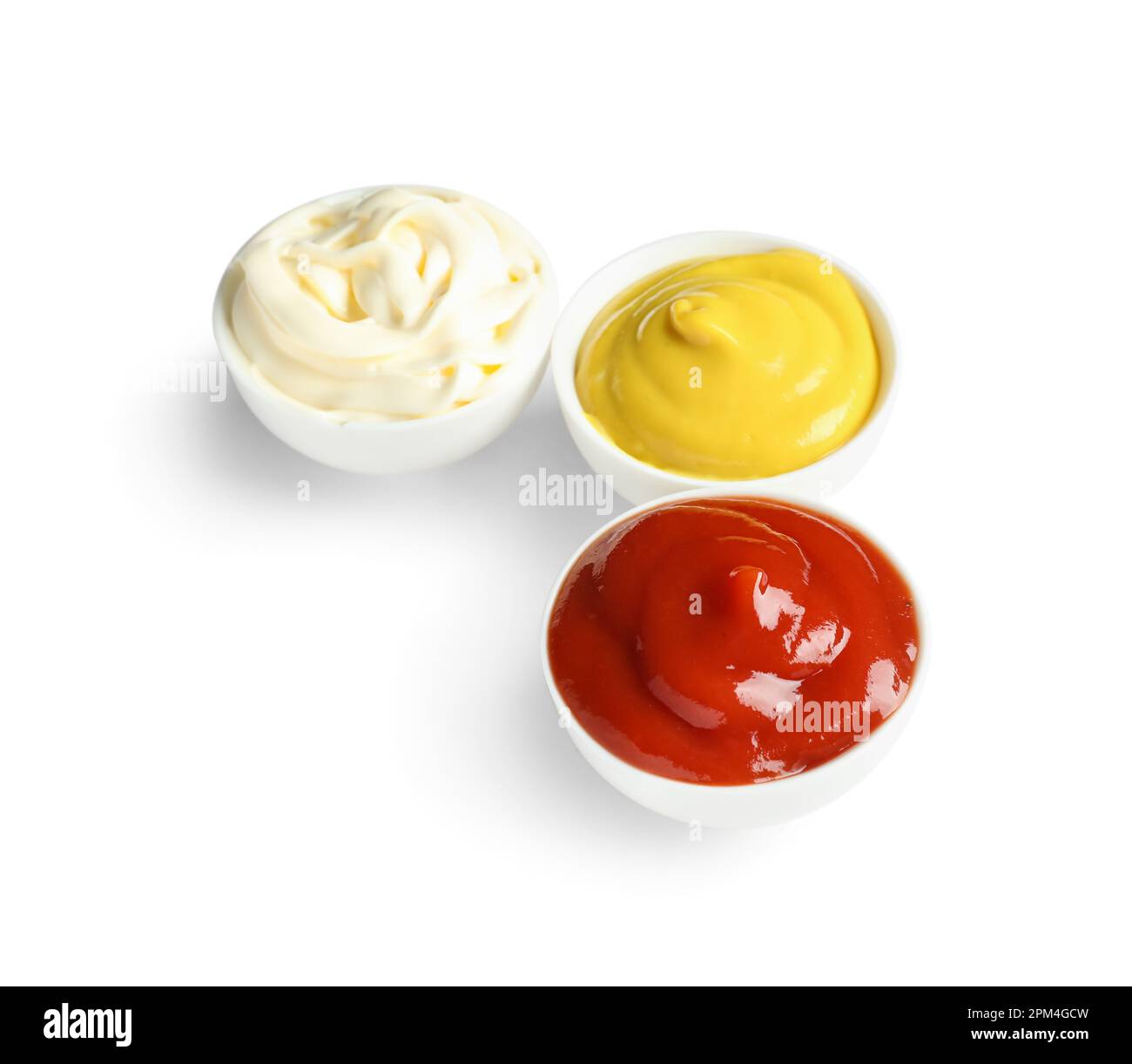Bowls of ketchup, mayonnaise and mustard isolated on white background ...