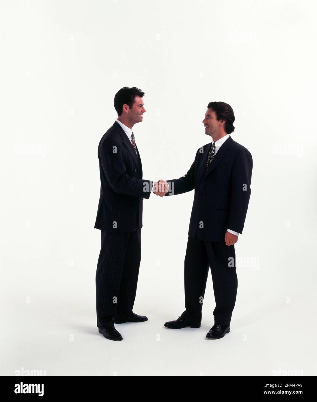 Business executives. Two young men shaking hands. Stock Photo