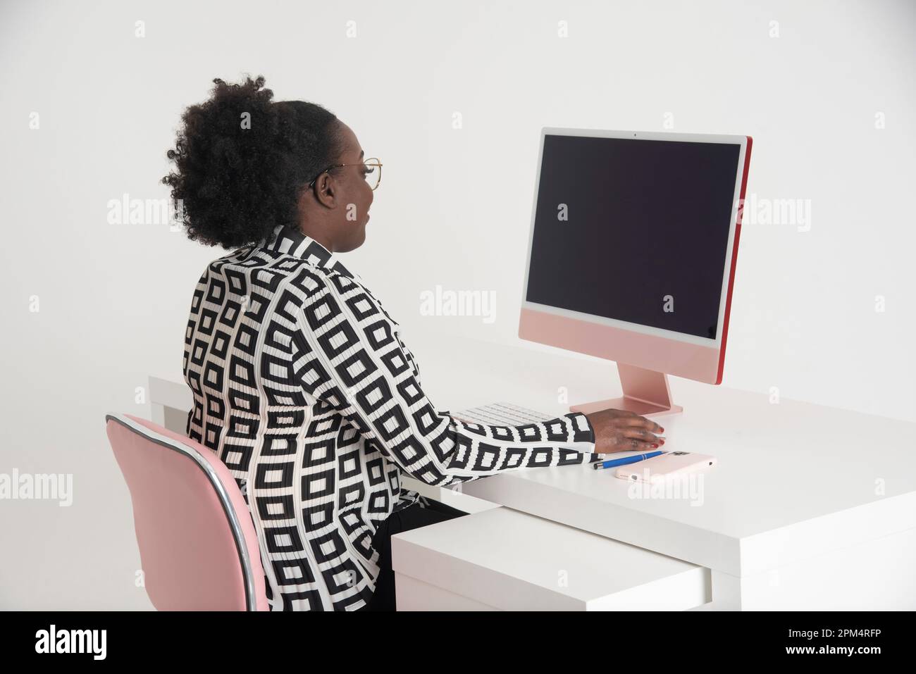 Person seated desk using computer hi-res stock photography and images ...