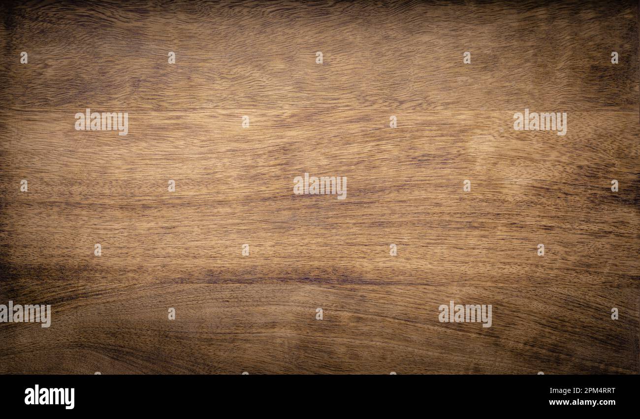 Dark brown rough grainy mango wood texture background Stock Photo
