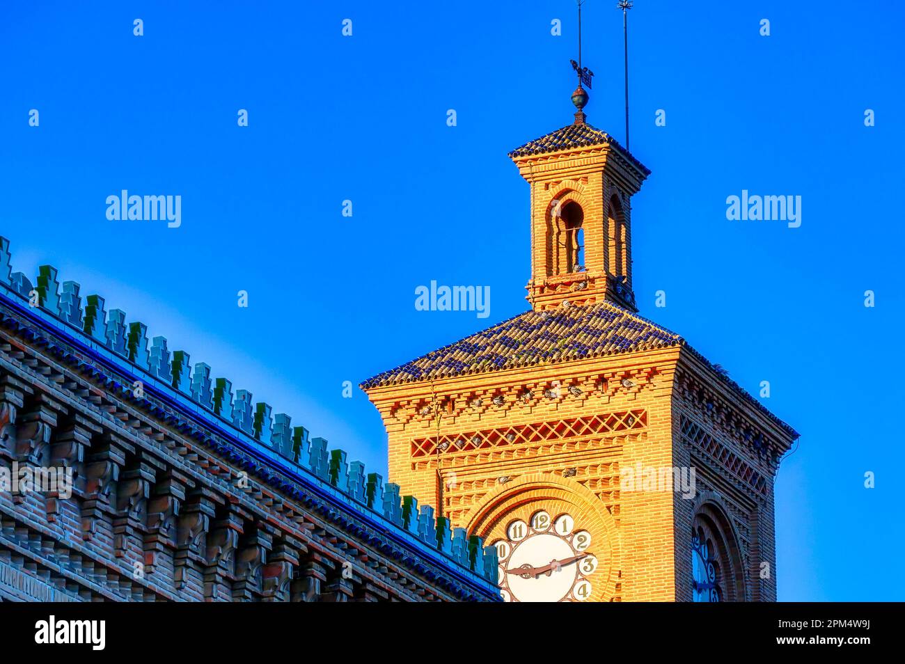 Clock tower building exterior. Old antique architecture of the Toledo AVE station. The transportation building is a famous place and tourist attractio Stock Photo